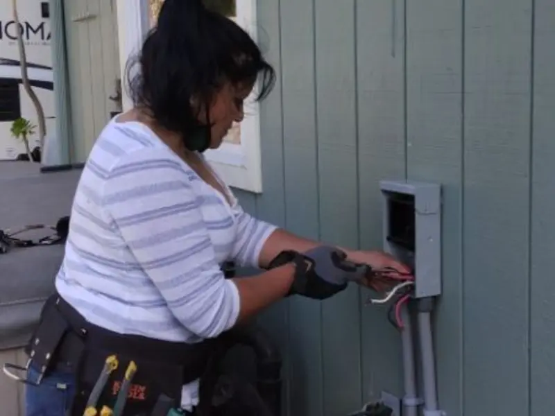 Licensed electrician wiring an exterior subpanel in Stickney